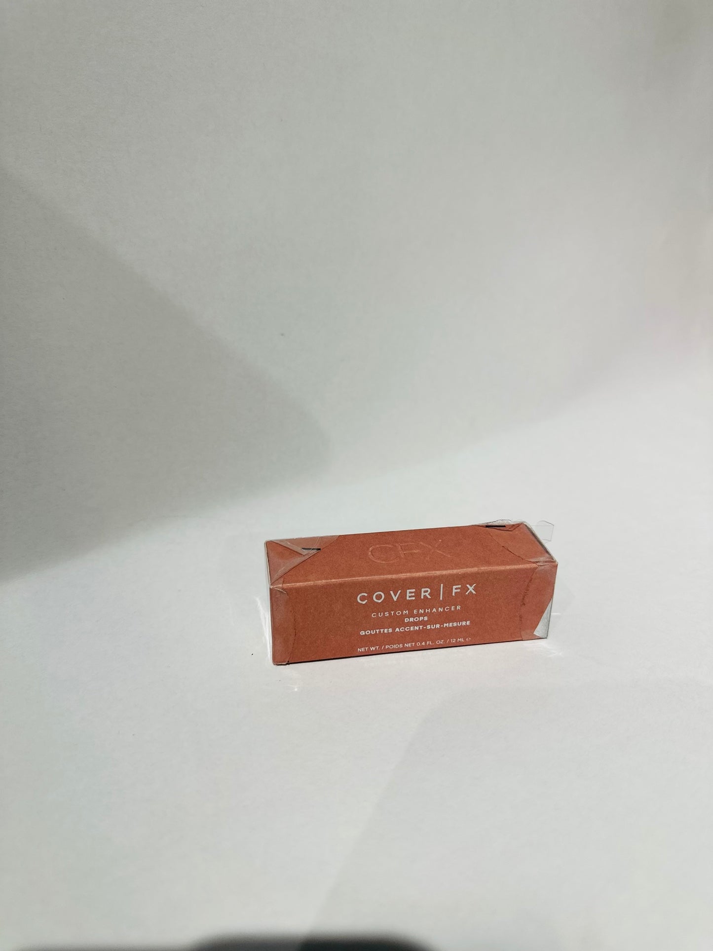 Cover FX Custom Enhancer Drops, a liquid highlighter designed to provide a customizable glow shade rose gold
