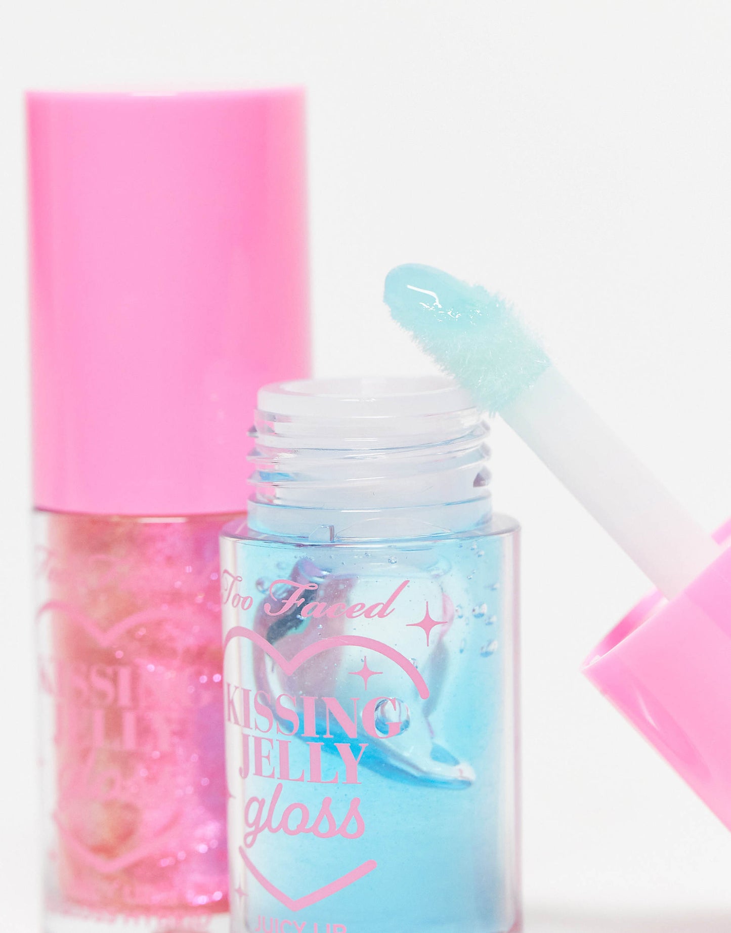 Too Faced Kissing Jelly Twice Upon A Time Limited Edition Lip Oil Gloss Duo includes two full-size hydrating lip oil-gloss hybrids in shades Bubblegum and limited-edition Blue Snow Cone.